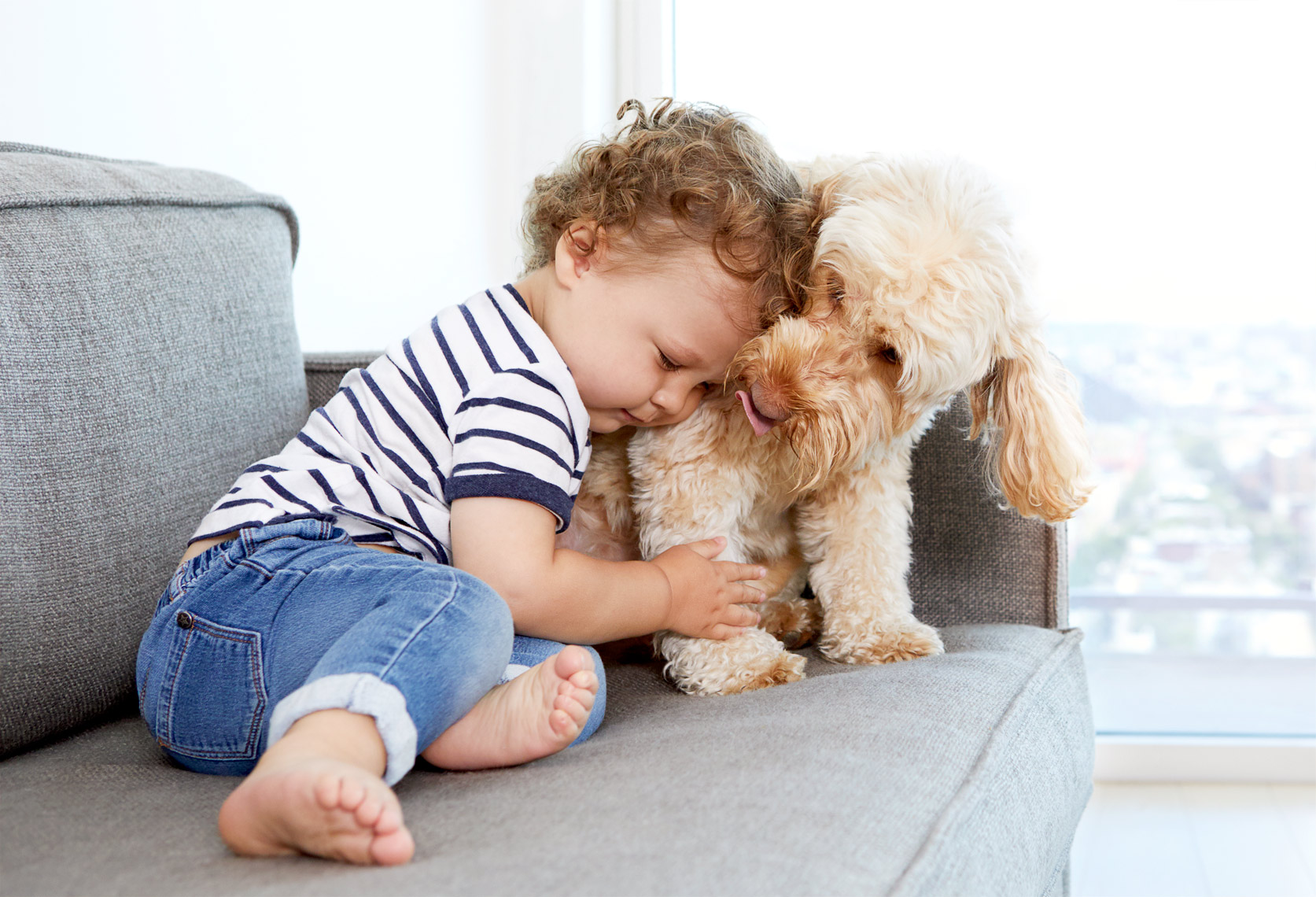 Toddler hugging dog