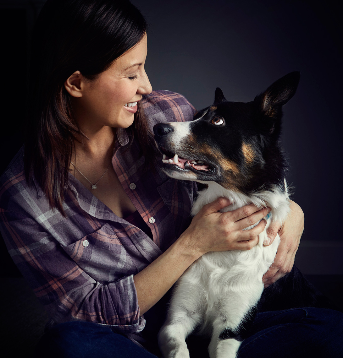 Woman embracing dog